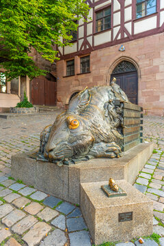 Close-up daytime view of the famous quirky bronze Durer Hare sculpture in a historic cobblestone square in the old town of Nuremberg, Germany