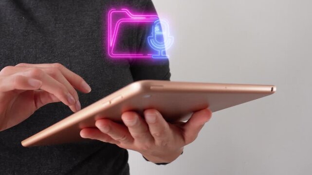 Audio file library. Close-up of a businesswoman interacting with her tablet, featuring a virtual folder icon with a microphone.