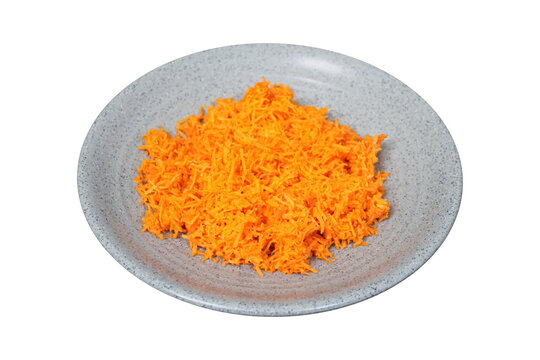 Fresh grated orange carrots served on grey plate isolated on transparent background