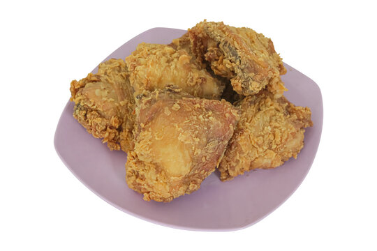 Crispy golden fried chicken pieces served on purple plate isolated on transparent background