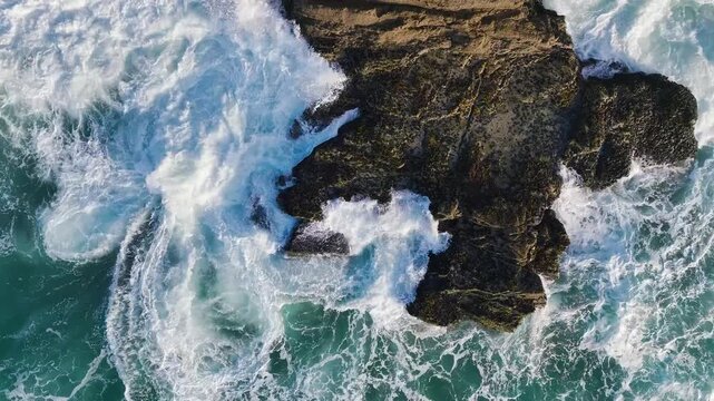 Top Down view over Waves and Cliffs from a drone, Cornwall, England, United Kingdom