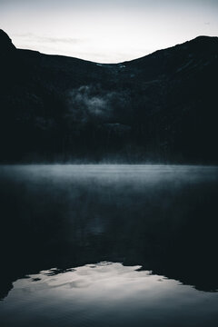 Mist above a still mountain lake in Cathedral Park