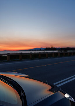 Sunset reflected on a car beside a road on Sea Island