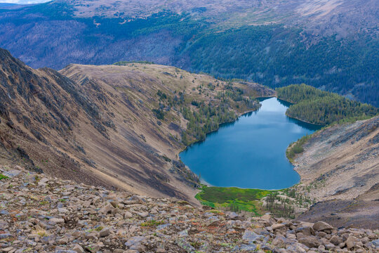 Blue alpine lake viewed from a rocky Cathedral Park ridge