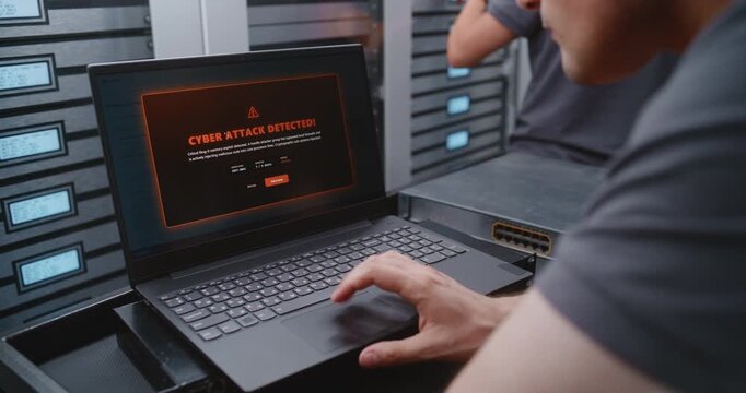 Male Cybersecurity Engineer Analyzes Cyber Attack Warning Through Terminal Interface, Checking System Health and Applying Emergency Console Procedures to Secure Critical Data Center Operations.