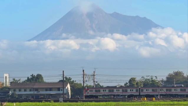Passenger Train Passing With Mount Merapi in the Background, Indonesia