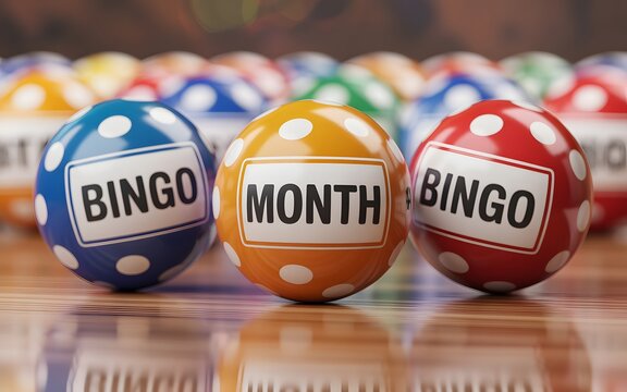 Three colorful bingo balls labeled bingo month sitting on a polished wooden surface