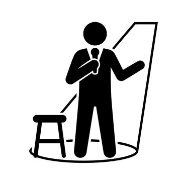 Black silhouette of a stand-up comedian performing on stage with a microphone and stool under a spotlight for entertainment.