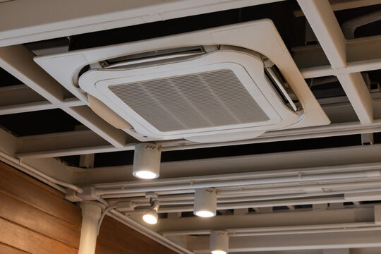 Ceiling air vent in a modern office environment with exposed ductwork