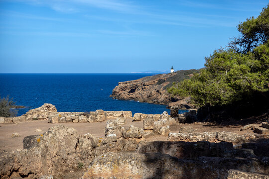 Mediterranean headland and lighthouse seen beyond the ruins of Tipasa