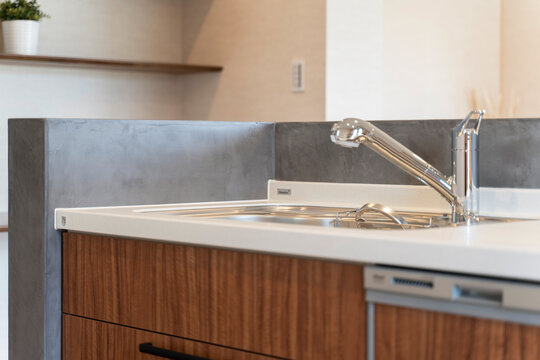 Modern kitchen with gray microcement finish and warm wooden cabinets