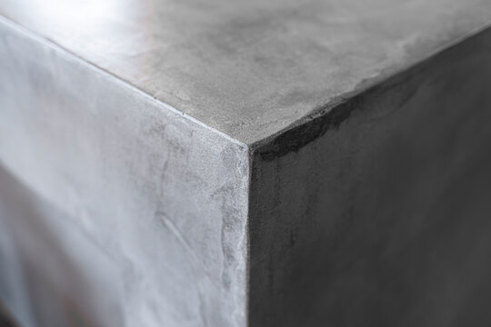 Close-up detail of gray microcement surface with handcrafted plaster texture