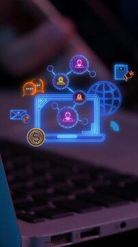 Laptop keyboard vertical shot with glowing screen displaying digital marketing network icons. Corporate online advertising campaign strategy, social media promotion, and audience outreach concept.