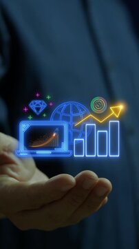Businessman open hand vertical shot supporting glowing laptop with rising growth chart and diamond. Financial investment analytics profitability, digital asset performance, and wealth idea concept.