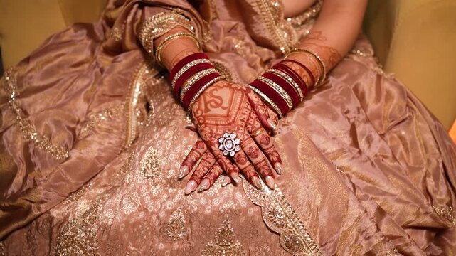 Indian bride with henna decorated hands wearing traditional bangles in Delhi