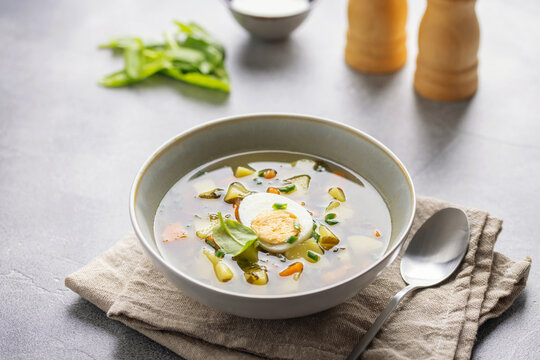 Delicious sorrel soup with leaves and egg in ceramic bowl. Spring soup with wild herbs
