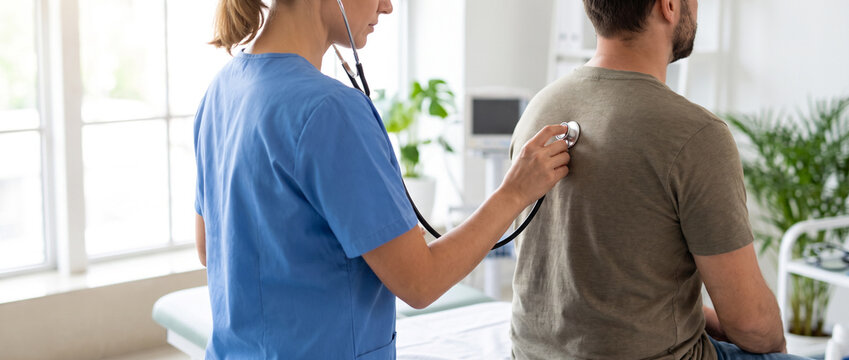 Pulmonologist examining patient breathing with stethoscope