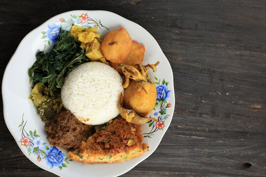 Nasi Padang Served with Rendang, Young Jackfruit Curry,  Cassava Leaves, and Sambal Hijau or Lado Mudo