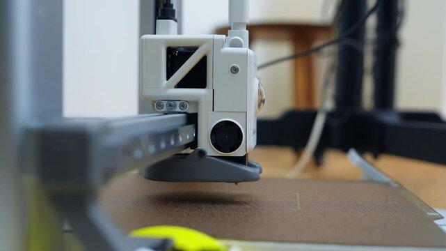 3D printer working in a small workshop in the afternoon