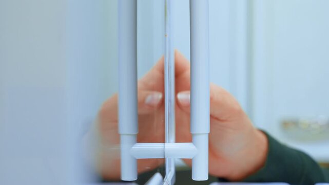 Hands interacting with a thin surface in a well-lit indoor space