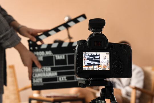 Film production and video content creation, filmmaker using a clapperboard on a professional camera set for a commercial interview or media project