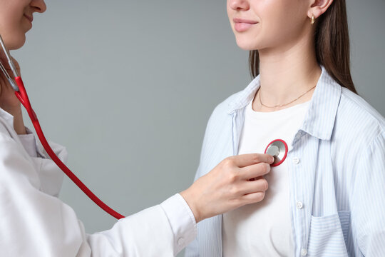 Medical checkup and health screening, doctor using stethoscope to examine patient heart rate and lung function in clinical consultation
