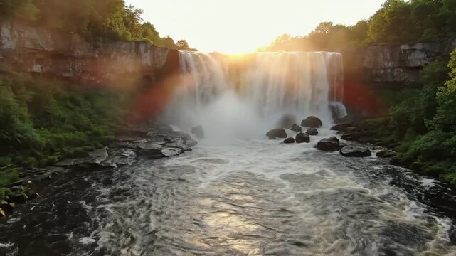 Rideau Falls in Ottawa surrounded by natural greenery and warm golden evening light, realistic flowing water and mist creating cinematic professional Canadian travel footage