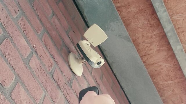 Controlling a surveillance camera above the entrance of a house with a remote