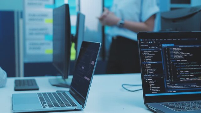 Asian happy woman and man programmer team coding software at computer in dark tech office, Concept of digital transformation, modern cyber security, startup teamwork and future IT digital network