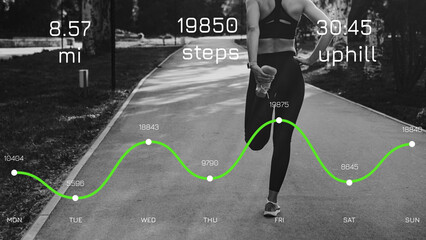Obraz premium Runner tracks distance and steps during a week of workouts in a park
