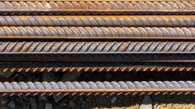 Steel reinforcement bars. Construction rebar steel work reinforcement. Industrial background. Stack of iron bars
