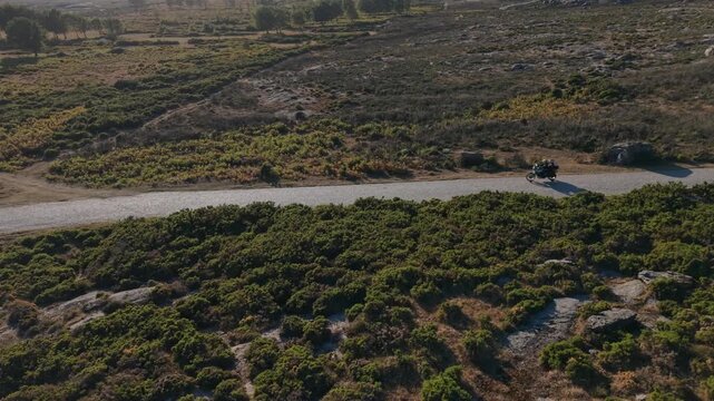 Motorcycle on empty mountain road in Viana do Castelo with gorse moorland and granite