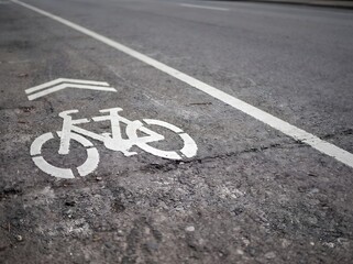 Obraz premium White Painted Bicycle Lane Road Markings Indicating Designated Path for Cyclists on Urban Asphalt Street Surface