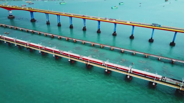 4K aerial drone video of a train crossing the historic Pamban Railway Bridge over the Palk Strait near Rameswaram, Tamil Nadu, India.