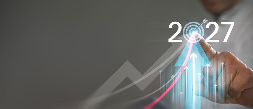 Business Growth and Year 2027 Target Goal Concept with Businessman Touching Upward Arrow Graphic.   