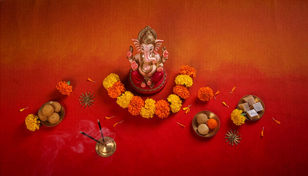 Beautiful Lord Ganesha idol decorated with vibrant yellow marigold flowers against a deep red background. Perfect for Ganesh Chaturthi festival greetings, cultural invitations, and Hindu religious ban