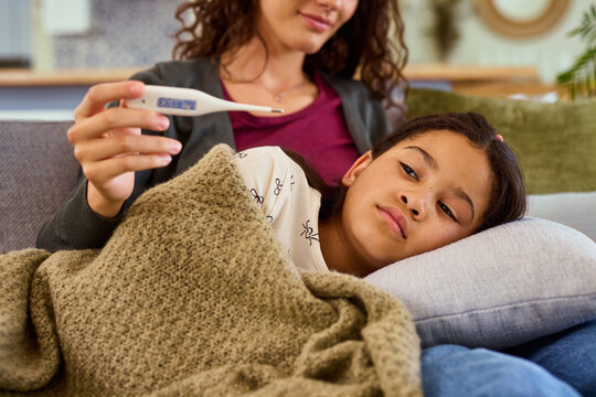 Sick mixed race little girl with fever