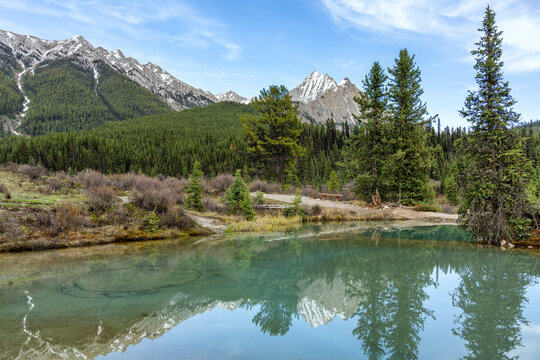 Ink Pots mineral springs reflecting mountains in Banff National Park