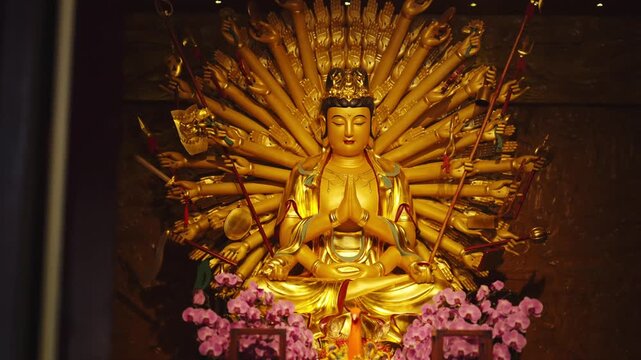 Sculpture of multi-armed god in Chinese Buddhists temple, religion and faith. Thousand-armed Guanyin, Bodhisattva, praying in pagoda, taoism and chinese folk religion, travel in china, Asian culture