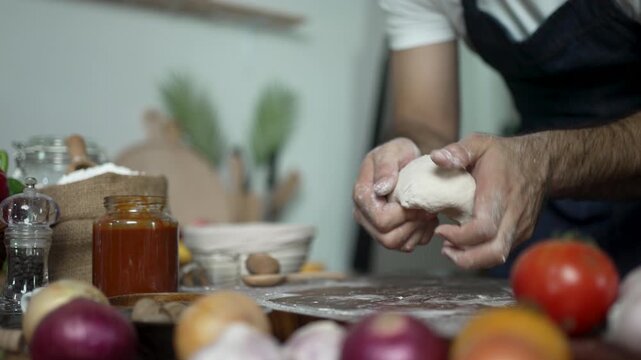 Hands Shape a Small Ball of Pizza Dough