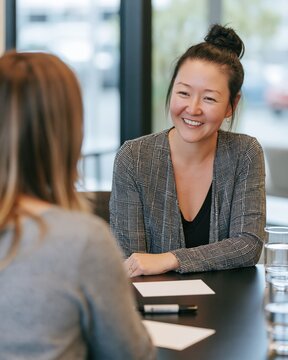 HR Coach Smiling During Supportive Employee Wellbeing Check-In Conversation