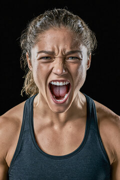 Fierce Determination A close-up portrait of a determined woman, her face contorted in a primal scream, embodying raw power and unwavering focus.