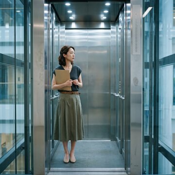 Generative AI, Asian businesswoman standing in glass elevator in modern building