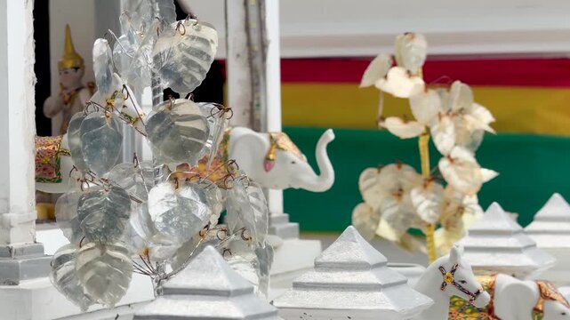 Silver Bodhi Leaves and Sacred Offerings at Buddhist Shrine