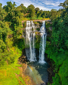 Aerial drone view of Tad Gneuang Waterfall in Laos, a spectacular tropical cascade surrounded by dense rainforest on the scenic Bolaven Plateau in Champasak Province.