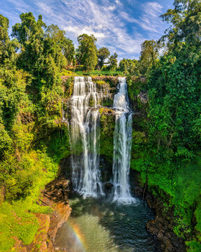 Aerial drone view of Tad Gneuang Waterfall in Laos, a spectacular tropical cascade surrounded by dense rainforest on the scenic Bolaven Plateau in Champasak Province.