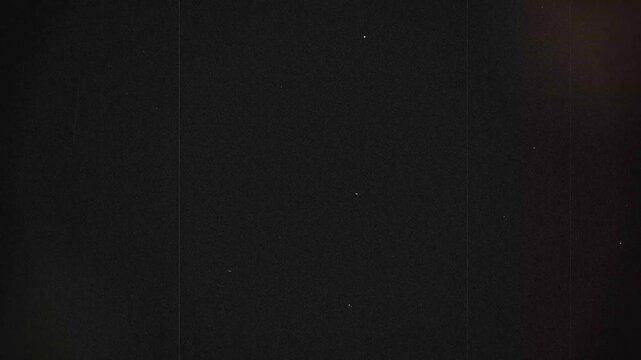 Vintage film grain texture with dust and scratches on black background