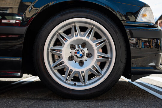 Kemptthal, Lindau, Switzerland, September 13, 2026. Close up view of a black BMW E36 M3 alloy wheel and front bumper.