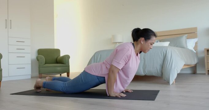 Lifestyle videos indoor of people doing activities at home, practicing yoga, woman stretching on yog