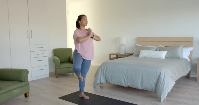 Lifestyle videos indoor of people doing activities at home, practicing yoga, woman stretching on yog